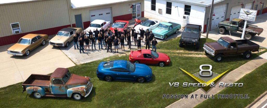 V8 Speed and Resto Shop Team with some of their personal cars and trucks in front of the shop.